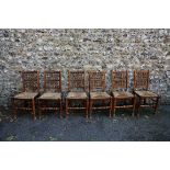 A set of six antique spindle back kitchen chairs having rush seats.This lot can only be collected on