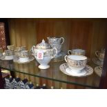 A Wedgwood 'Gold Florentine' pattern part tea service, comprising: sucrier & cover; sugar bowl; milk