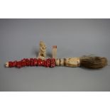 A Chinese bone and coral calligraphy brush, 36cm long; together with an ivory seal, 5.7cm long;