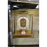 A vintage Kundo brass electromagnetic timepiece, 23.5cm high.