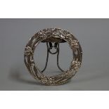 A Chinese silver easel back circular frame, pierced and decorated with floral motifs, aperture 8.9cm