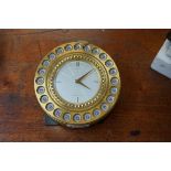 A vintage Gubelin 'Select-O-Time' novelty brass timepiece, 12cm diameter.