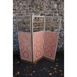 An Edwardian three fold screen with glass and pink floral fabric panels, 151cm high. This lot can
