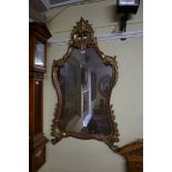 An antique carved giltwood framed wall mirror, 113 x 59cm.