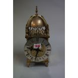 A reproduction small lantern style clock, 26.5cm high.