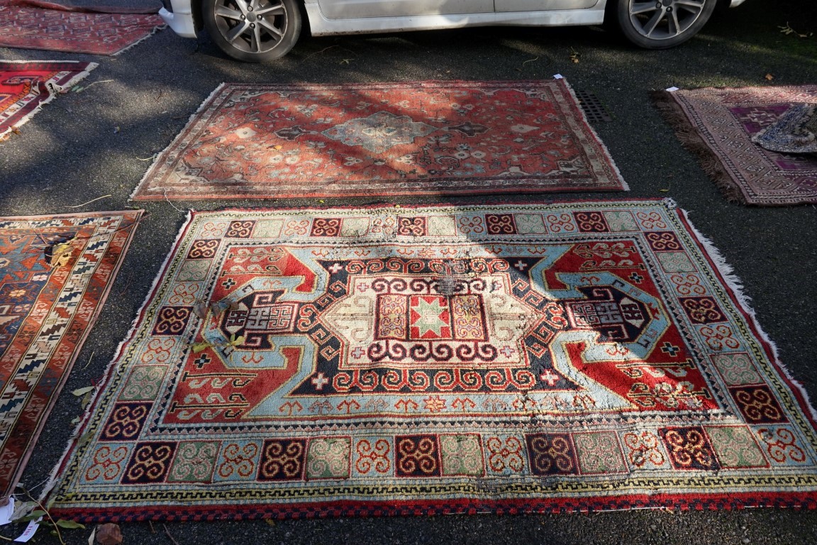 A Persian rug, having geometric borders, 198 x 140cm; together with one other rug having floral