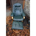 A modern green leather adjustable armchair; together with a matching footstool. This lot can only be