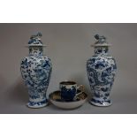 A pair of Chinese blue and white vases and covers, painted with dragons, 22.5cm high; together