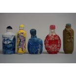 Five various Chinese snuff bottles and stoppers, to include a tea dust glazed example, 7cm high. (5)