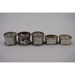 A pair of Edwardian pierced silver napkin rings, by Walker & Hall, Sheffield 1901; together with
