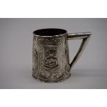 A Malaysian white metal tankard, decorated figure and rhyme, 8cm high.