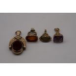 An onyx and gold swivel fob, stamped 10k; together with an amethyst set fob seal, hallmarked 375;