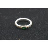 A designer emerald white gold ring, by Barbara Tipple, hallmarked 18ct, the shank decorated yellow