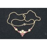 A diamond and ruby set gold necklace, the clasp stamped 10k, 8.7g gross weight.