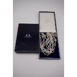 A seven row pearl choker, the clasp stamped 375, having Mappin & Webb case and box; together with