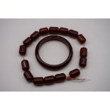 A string of cherry amber beads, 36cm long; together with a similar bangle, 106.4g