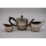 An Edwardian silver three piece bachelor's tea set, by Robert Pringle & Sons, London 1903/4, 11cm