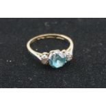 A diamond and blue topaz gold ring, hallmarked 18ct.
