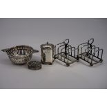 A small group of silver items, to include: a pair of individual toast racks, a tea strainer etc,