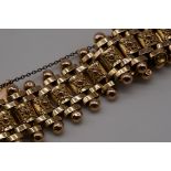 A Victorian Etruscan revival yellow metal bracelet, 25mm deep.