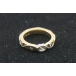 A designer diamond gold ring, by Barbara Tipple, hallmarked 750, the oval diamond and trailing