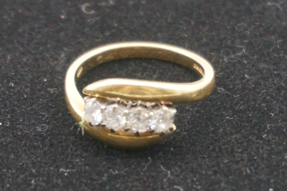 A diamond gold twist ring, hallmarked 750, set four diamonds of approximately 0.5ct, 5.2g gross - Image 2 of 3