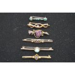 Five various gem set yellow metal bar brooches; together with another metal example. (6)