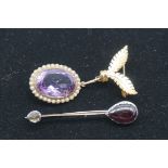 A large oval amethyst and seed pearl pendant, stamped 9ct, having a metal brooch fitting attached,