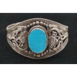 An Asian white metal and turquoise cuff bangle.