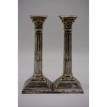 A pair of silver Corinthian column candlesticks, by Britton, Gould & Co, Birmingham 1931, 24cm high.