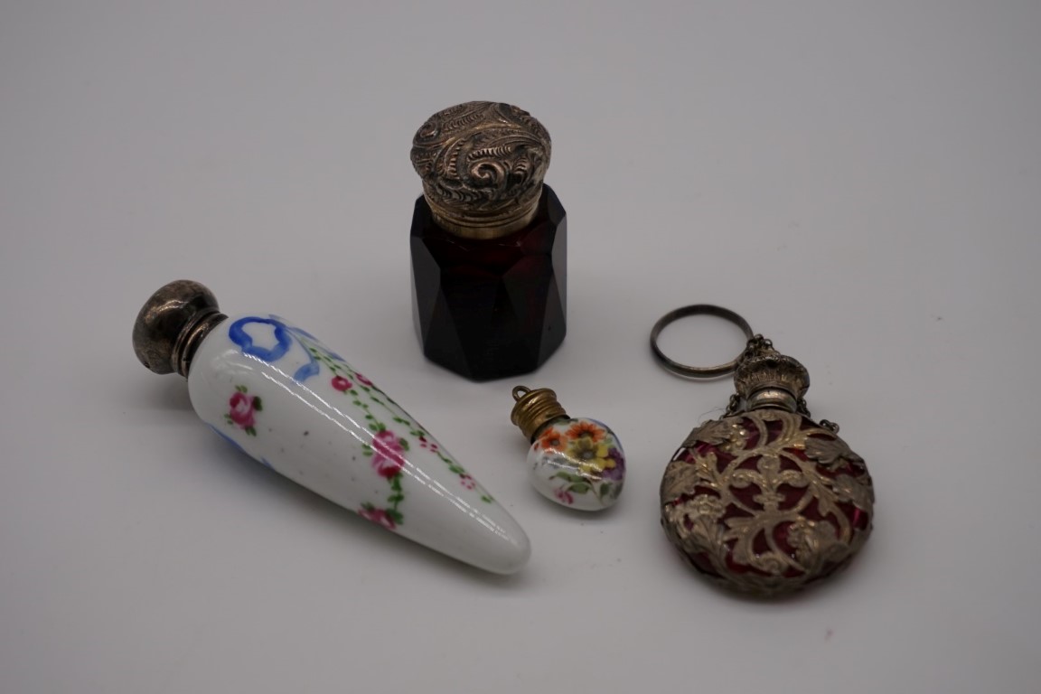 Two silver lidded scent bottles; together with two others. (4)