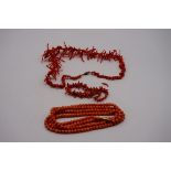 A coral bead necklace, having yellow metal clasp; together with a branch coral example; and a