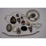 A selection of silver and other metal jewellery, to include bangle, brooches and pendants.