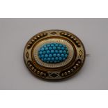 An Etruscan revival oval turquoise and enamel yellow metal mourning brooch, 43 x 33mm.