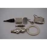 A small group of various silver and silver mounted trinkets, to include a 'Golly' teething ring,