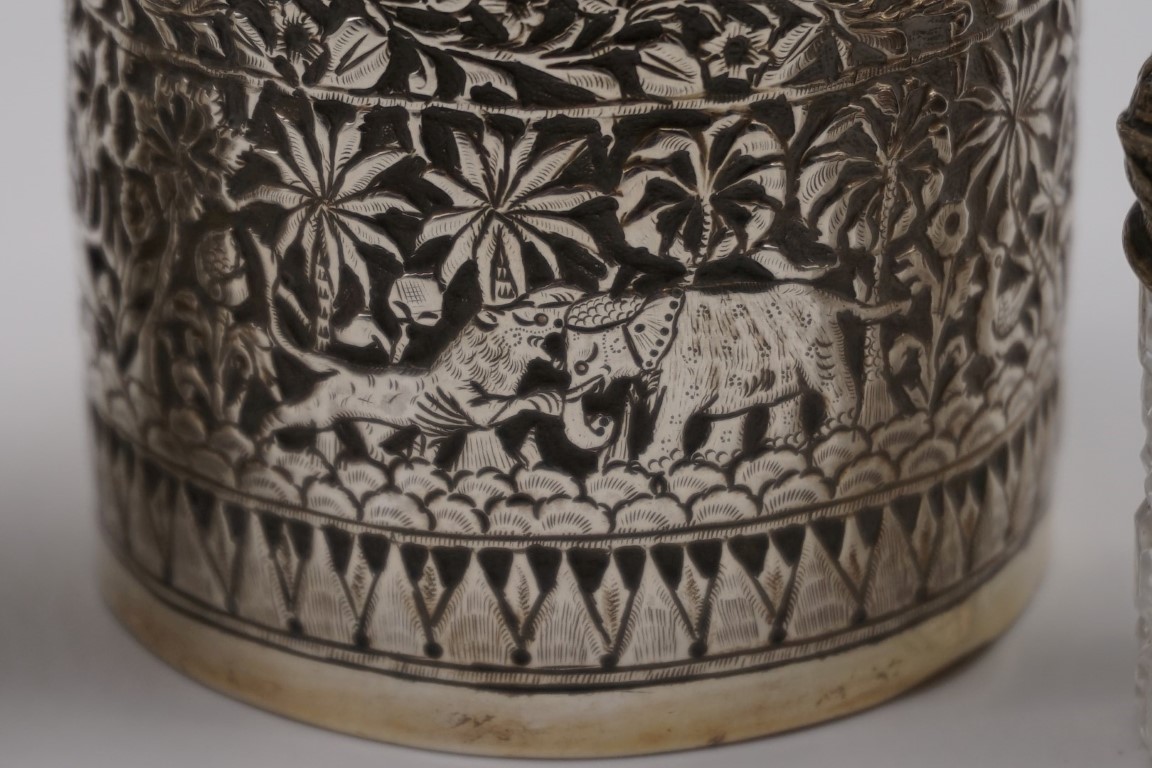 An Indian white metal pot and cover, decorated jungle foliage and animals, 6.5cm high; together with - Image 2 of 4