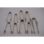 Nine pairs of decorative silver sugar nips, various makers and dates, 204g.
