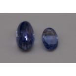 An unmounted oval tanzanite gemstone,approximately 5.5ct; together with a similar 2ct circular