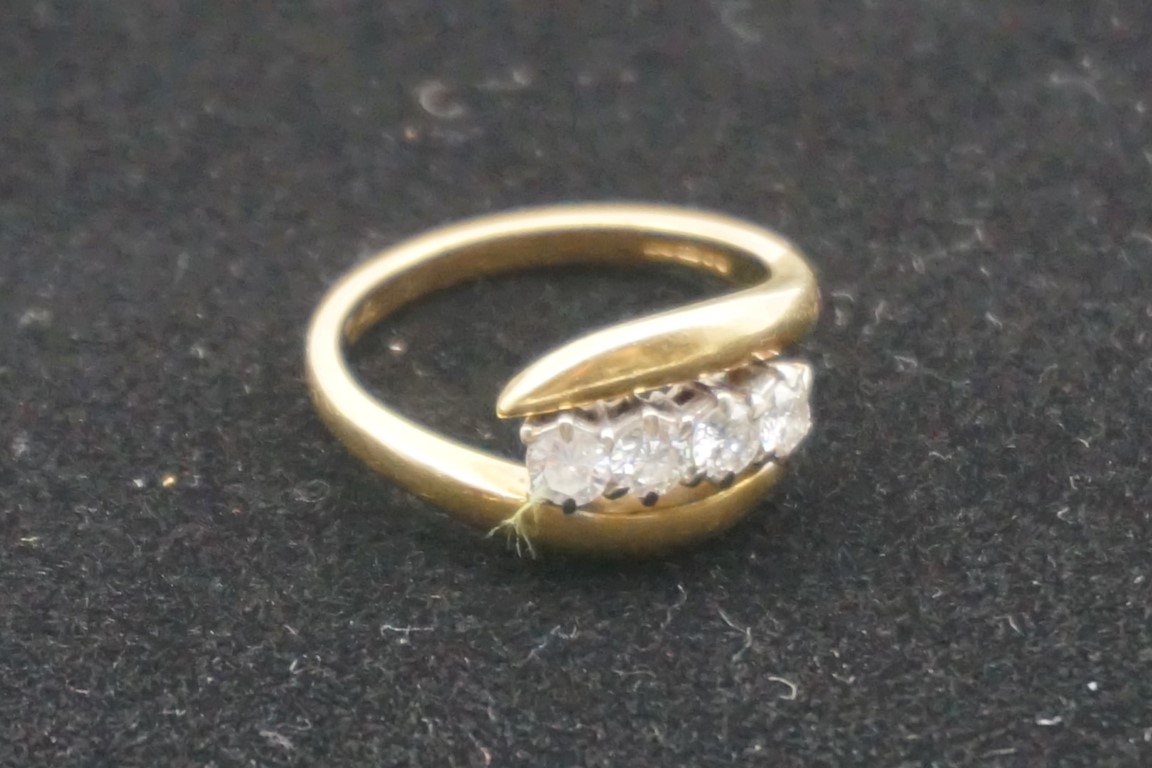 A diamond gold twist ring, hallmarked 750, set four diamonds of approximately 0.5ct, 5.2g gross