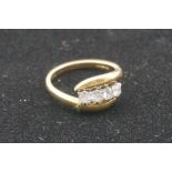 A diamond gold twist ring, hallmarked 750, set four diamonds of approximately 0.5ct, 5.2g gross