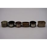 Five various silver napkin rings, 118g; together with a pewter example. (6)