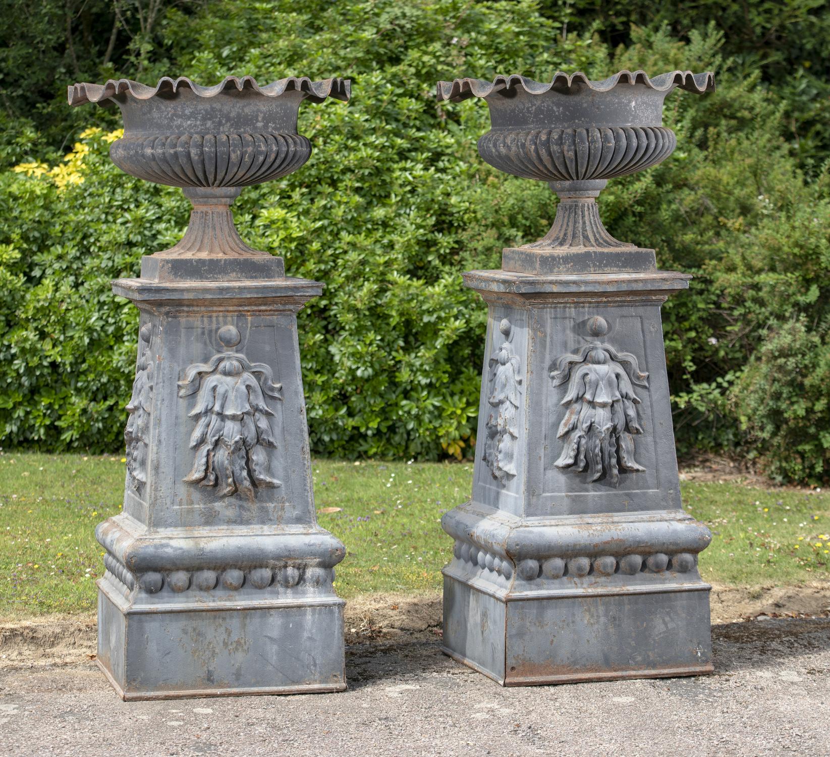 Garden urns/pots/planters: A large and impressive pair of cast iron urns on pedestals, French