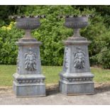 Garden urns/pots/planters: A large and impressive pair of cast iron urns on pedestals, French