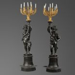 Interior Design: A pair of cast iron putti candelabra figures, French, last quarter 19th century, on