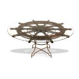 Tables: A large brass and iron mounted wooden ships wheel, 19th century, now mounted as a table with