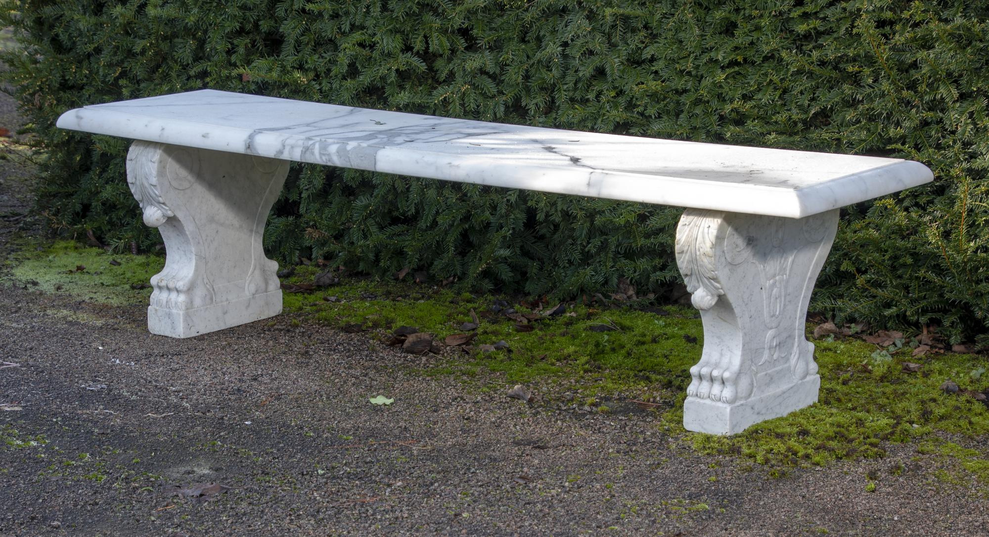 Garden seats: A carved white marble bench, Italian, circa 1900, with later veined marble top,