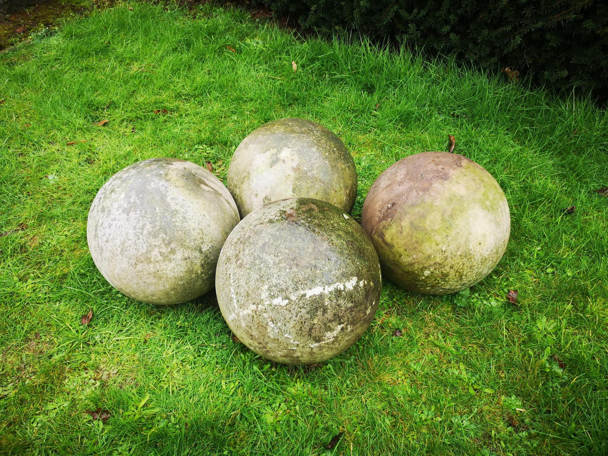 Finials: A set of four carved stone balls, 35cm diameter