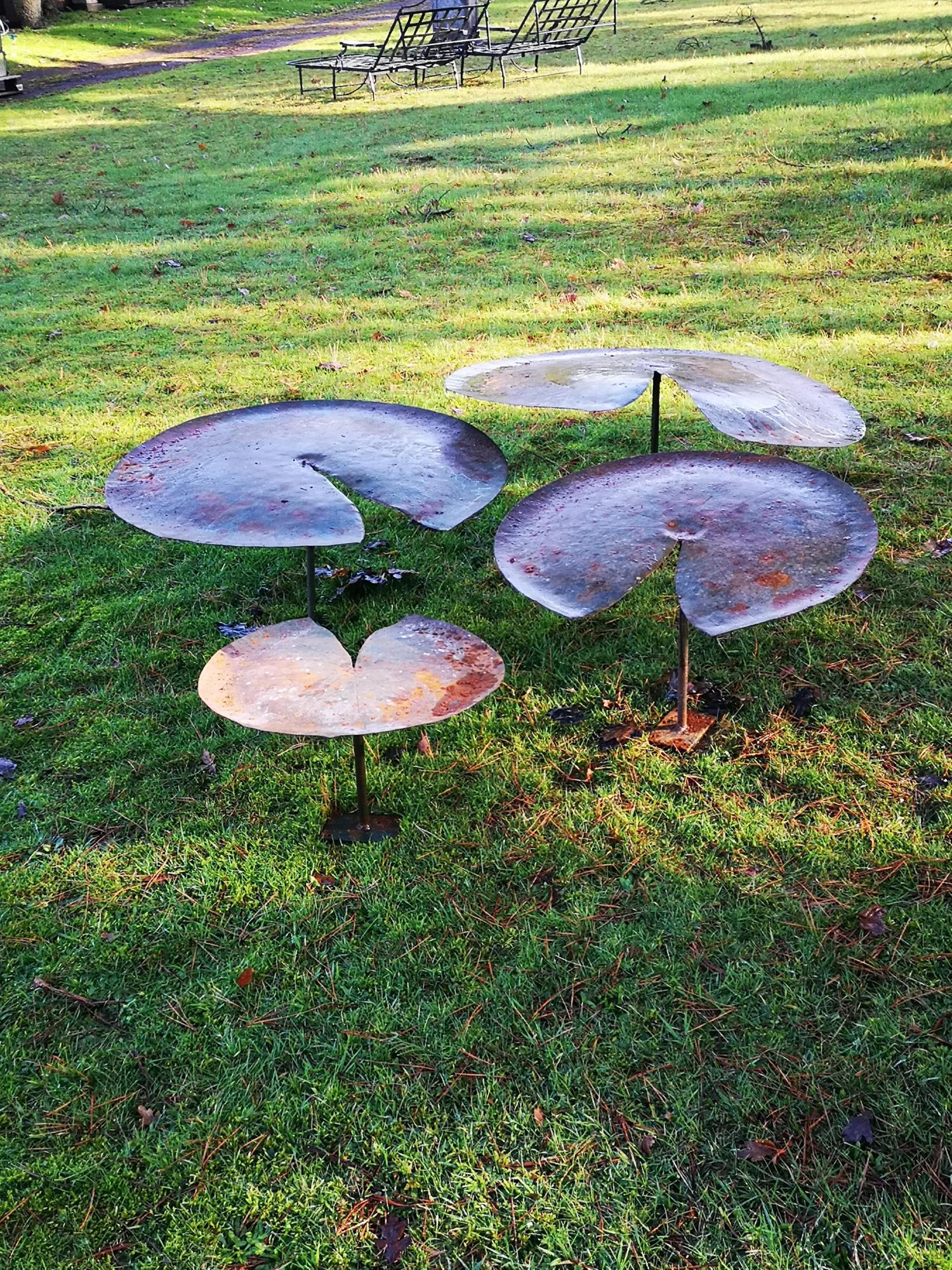 Garden Sculpture: A graduated set of four sheet iron lilies with iron supports, the largest 90cm