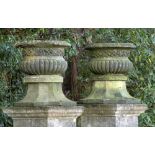 Garden pots/planters: A pair of Victorian carved sandstone urns, circa 1870, on associated