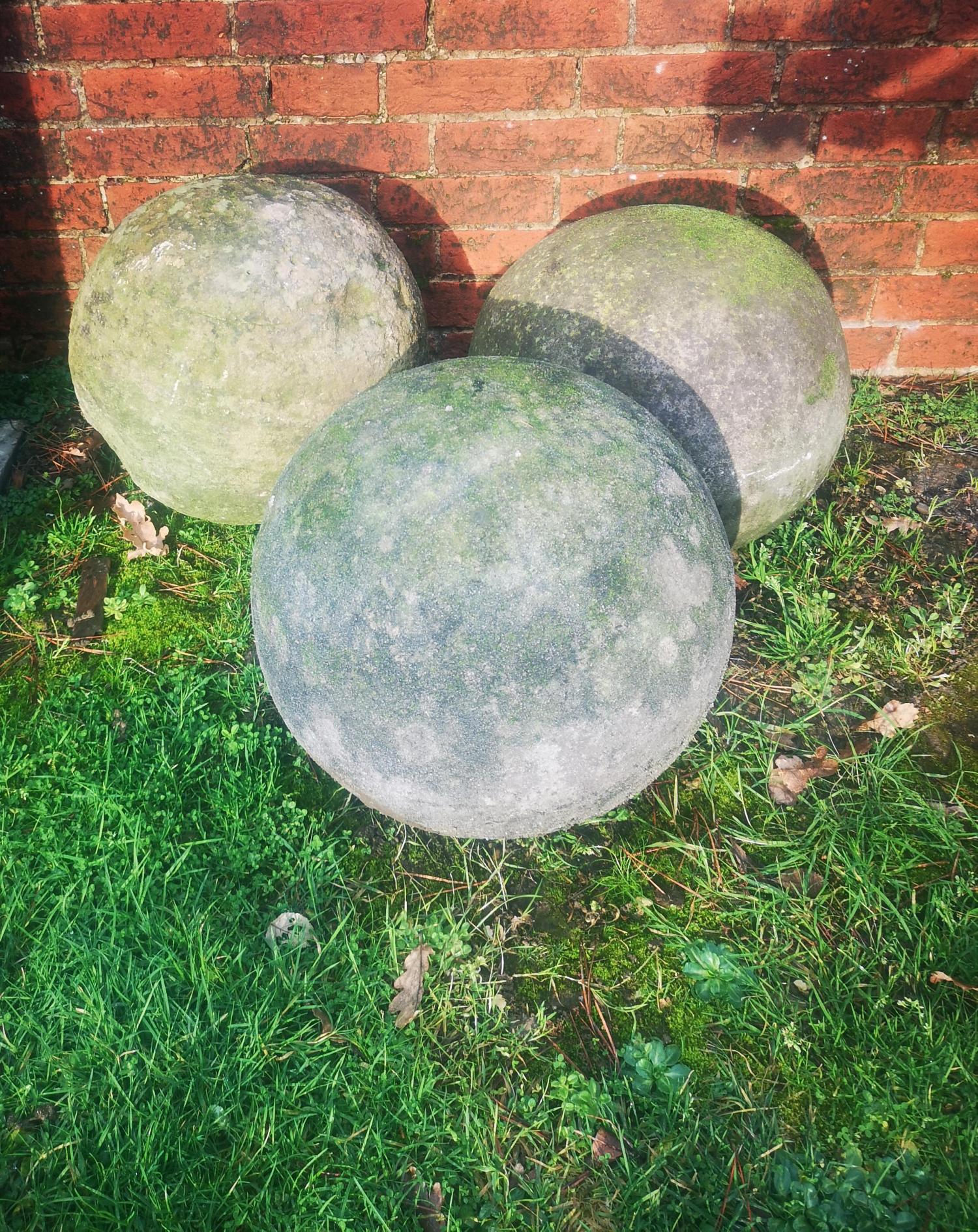 Finials: Three composition stone gate pier balls, 38cm diameter